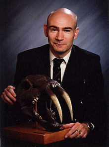 220px-Dr_Karl_P._N._Shuker_and_Smilodon_Skull