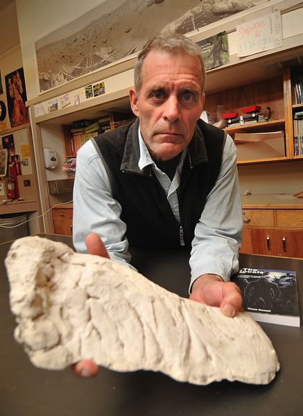 CONNECTION PHOTO: VERN UYETAKE - Eighth-grade science teacher Thom Powell with a plaster track cast of the Sasquatch in his classroom at Robert Gray Middle School.